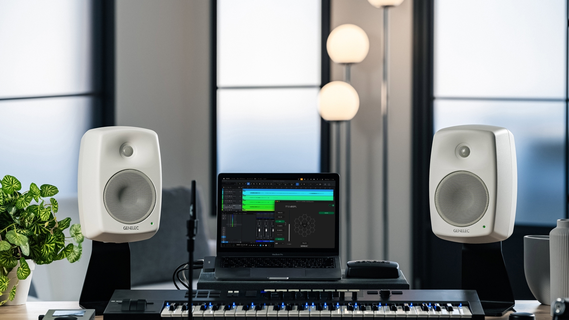 Genelec nearfield studio monitors in a compact music and content creation workspace