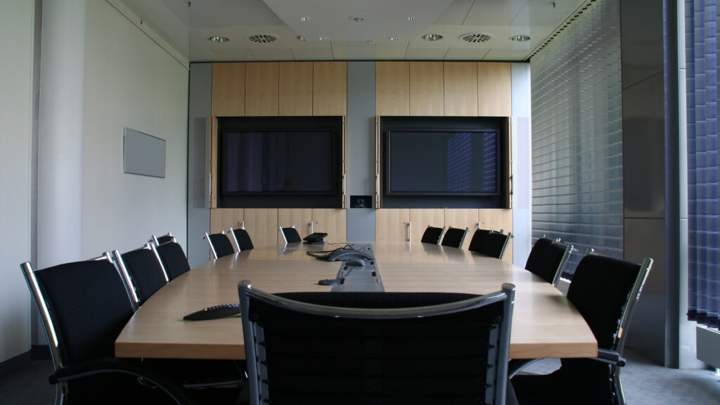 Corporate boardroom with dual integrated display screens for AV-over-IP video distribution