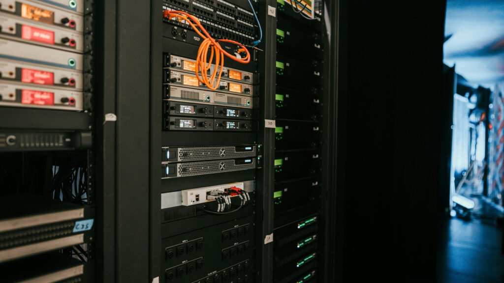 Professional AV rack installation with network switch, wireless receivers, and structured cabling